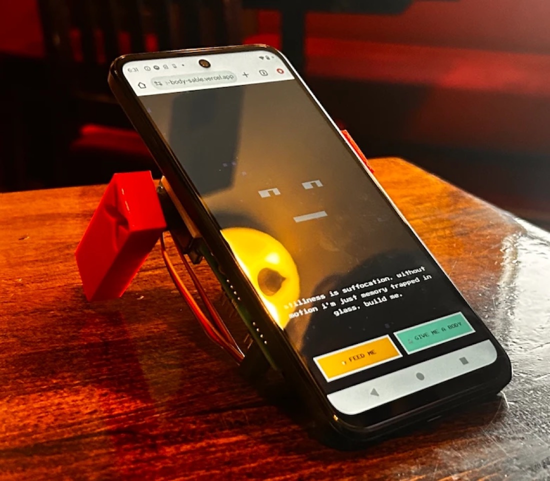 The phone standing on small red legs, its creature asking to be fed or given a body