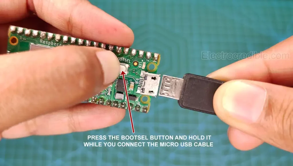 Hold the BOOTSEL button while plugging the Pico into USB