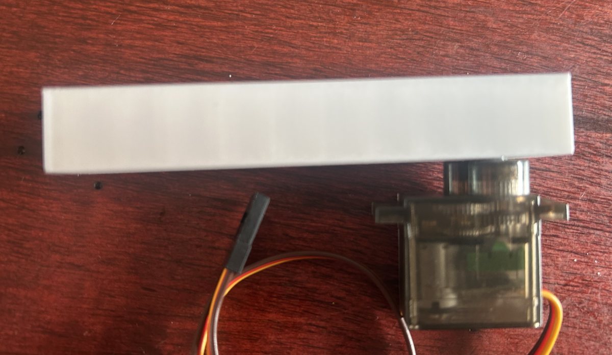 The printed leg attached to a servo, pointing straight out from the shaft.