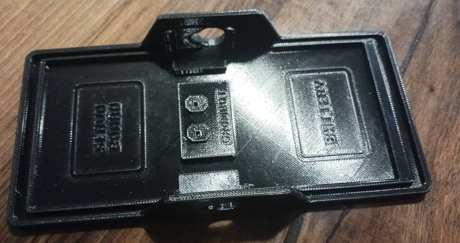 The printed plate laid flat and horizontal, with SERVO BOARD moulded into one end, GROWBOT and two screw holes in the middle, and BATTERY at the other end.
