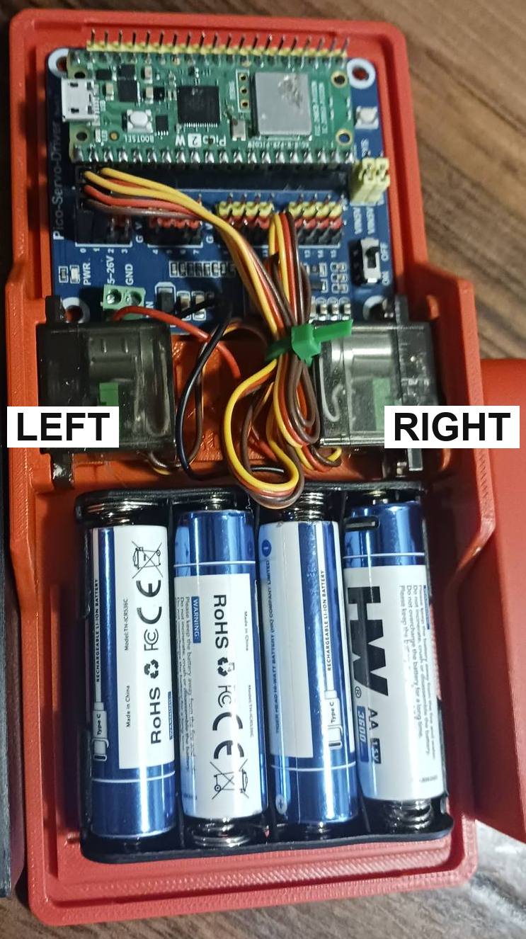 Looking down at the plate with the batteries at the bottom, the servo on the left marked LEFT and the servo on the right marked RIGHT.