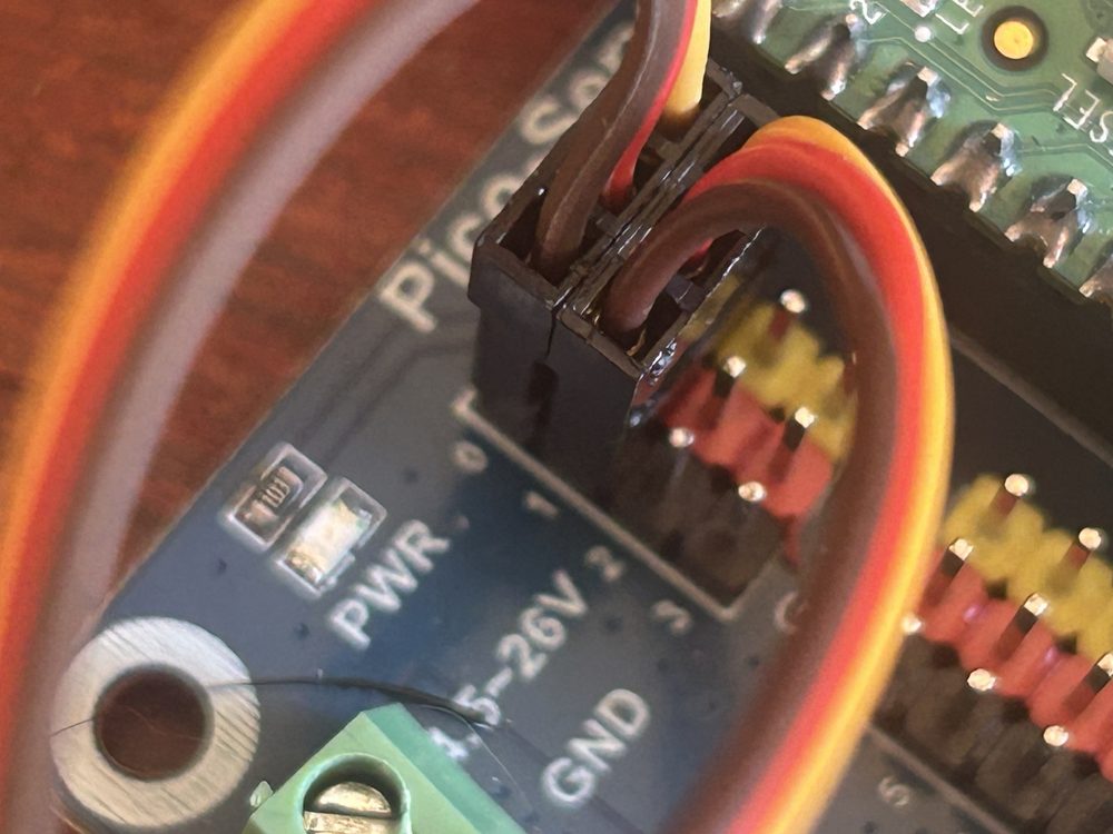 Both servo plugs seated in sockets 0 and 1 on the Waveshare board, wire colors matching the board's printed G V S order.